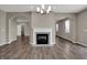 Bright living room featuring an elegant fireplace, arched doorways, and hardwood floors at 1704 Beach St, Greenwood, IN 46143