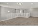 A loft area featuring plush carpeting, modern light fixture and staircase at 1704 Beach St, Greenwood, IN 46143