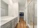 Bathroom with double sinks, a large mirror, and a glass-enclosed shower at 19257 Red Willow Ln, Noblesville, IN 46062