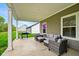 Covered patio with an outdoor grill and wicker seating, perfect for entertaining guests at 19257 Red Willow Ln, Noblesville, IN 46062