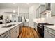 Modern kitchen boasts stainless steel appliances, sleek countertops, and stylish wooden flooring at 19257 Red Willow Ln, Noblesville, IN 46062