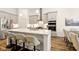 Contemporary kitchen with stainless steel appliances, quartz countertops, and seating at the center island at 19257 Red Willow Ln, Noblesville, IN 46062