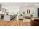Spacious living room open to the kitchen, featuring a large island and stainless steel appliances at 19257 Red Willow Ln, Noblesville, IN 46062