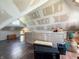 Attic with hardwood floors, drywall, window, wood furniture, and boxes at 201 N Tacoma Ave, Indianapolis, IN 46201