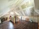 Spacious attic with hardwood floors, white walls, and window at 201 N Tacoma Ave, Indianapolis, IN 46201