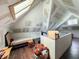 Attic with sloped ceiling, hardwood floors, teddy bears, windows and exposed drywall at 201 N Tacoma Ave, Indianapolis, IN 46201
