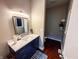 Bathroom with vanity, mirror, dark wood floor, toilet in separate room, and overhead lighting at 201 N Tacoma Ave, Indianapolis, IN 46201