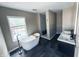 Modern bathroom featuring a soaking tub, walk-in shower, and dual vanities for a spa-like feel at 201 N Tacoma Ave, Indianapolis, IN 46201