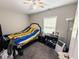 Comfortable bedroom with ceiling fan, natural light, and carpeted floors at 201 N Tacoma Ave, Indianapolis, IN 46201