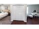 Spacious bedroom with a closet that features louvered doors and a vanity with natural light at 201 N Tacoma Ave, Indianapolis, IN 46201