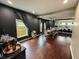 Dining room with grey walls, hardwood floors and ample lighting with a view to the kitchen at 201 N Tacoma Ave, Indianapolis, IN 46201