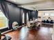 Dining room with grey walls, hardwood floors and ample lighting with a view to the kitchen at 201 N Tacoma Ave, Indianapolis, IN 46201