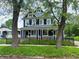Charming two-story blue home with white trim, well-manicured lawn and black metal fence at 201 N Tacoma Ave, Indianapolis, IN 46201