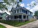 Picture of a two-story blue home with white trim and a black metal fence at 201 N Tacoma Ave, Indianapolis, IN 46201