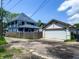 Exterior view of garage with driveway, neighboring home and yard at 201 N Tacoma Ave, Indianapolis, IN 46201