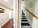 Hallway with wood floors, bike, and staircase with wooden handrail at 201 N Tacoma Ave, Indianapolis, IN 46201