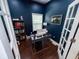 Home office with navy walls, a desk setup, bookshelf, and French doors at 201 N Tacoma Ave, Indianapolis, IN 46201