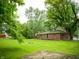 Expansive backyard featuring mature trees, a well-maintained lawn, and room for outdoor activities at 21 Roderick Ct, Beech Grove, IN 46107