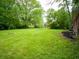 Backyard showing mature trees, well-kept lawn, and a tranquil outdoor space at 21 Roderick Ct, Beech Grove, IN 46107