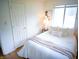 Cozy bedroom with a comfortable bed, white linens, neutral colored blanket, and natural light at 21 Roderick Ct, Beech Grove, IN 46107