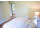 Cozy bedroom with a comfortable bed, soft throw blanket, and hardwood floors at 21 Roderick Ct, Beech Grove, IN 46107