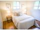 Comfortable bedroom with hardwood floors, two windows, neutral colors, and modern bedside tables at 21 Roderick Ct, Beech Grove, IN 46107