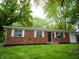 Inviting brick home featuring a well-maintained lawn and cozy front entrance at 21 Roderick Ct, Beech Grove, IN 46107