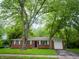 Charming brick home with mature trees providing shade and curb appeal at 21 Roderick Ct, Beech Grove, IN 46107