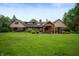 Large grassy backyard with custom timber pergola, stone pavers, and beautiful landscaping at 2411 N County Road 500 W, Muncie, IN 47304