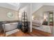 Modern bathroom with soaking tub, skylight, and view to main bedroom at 2411 N County Road 500 W, Muncie, IN 47304