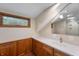 Bathroom with a vanity, large mirror reflecting the shower, and a natural wood trimmed window at 2411 N County Road 500 W, Muncie, IN 47304