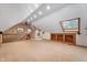 Bright bonus room featuring vaulted ceilings, built-in shelves, and a cozy window seat at 2411 N County Road 500 W, Muncie, IN 47304