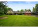 Ranch home with brick facade, attached garage and lush green lawn at 2411 N County Road 500 W, Muncie, IN 47304