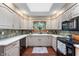 Well-lit kitchen features stone backsplash, stainless appliances, and lots of counter space at 2411 N County Road 500 W, Muncie, IN 47304