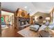 Cozy living room featuring brick fireplace, vaulted ceilings and hardwood floors at 2411 N County Road 500 W, Muncie, IN 47304
