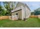 Spacious backyard with a well-maintained lawn, wood fence, and an elevated deck at 2429 N Centennial St, Indianapolis, IN 46222