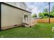 Lush backyard featuring a deck with white railing, grassy area and wood fence at 2429 N Centennial St, Indianapolis, IN 46222