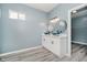 A modern bathroom featuring double sinks, a sleek vanity, and light blue walls at 2429 N Centennial St, Indianapolis, IN 46222