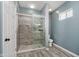 Bathroom with a glass-enclosed shower, gray stone tiles and neutral fixtures at 2429 N Centennial St, Indianapolis, IN 46222