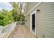 A wooden deck with a white railing and a view of lush greenery at 2429 N Centennial St, Indianapolis, IN 46222