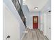 Inviting entryway with wood floors, stairs, and bright red door at 2429 N Centennial St, Indianapolis, IN 46222