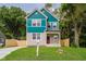 Charming two-story home with stone accents, green lawn, and colorful siding at 2429 N Centennial St, Indianapolis, IN 46222