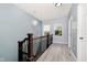Upstairs hallway with chandelier lighting, wooden trim and railing details at 2429 N Centennial St, Indianapolis, IN 46222