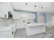 Modern kitchen with white cabinets, island, and stainless steel appliances at 2429 N Centennial St, Indianapolis, IN 46222