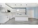 Modern kitchen featuring white cabinets, a kitchen island, and gray wood-look floors at 2429 N Centennial St, Indianapolis, IN 46222