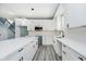 Modern kitchen with white cabinets, a large island, and stainless steel microwave at 2429 N Centennial St, Indianapolis, IN 46222