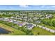 Expansive aerial view of a residential community, featuring homes with ponds, lush landscaping, and mature trees at 2485 Alexandra Dr, Carmel, IN 46074