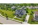 Gorgeous aerial view of a well-maintained home with green lawn, landscaping, and tree-lined streets at 2485 Alexandra Dr, Carmel, IN 46074