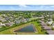 Overhead view of pond surrounded by lush lawns and landscaping, within a residential neighborhood at 2485 Alexandra Dr, Carmel, IN 46074