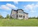 Beautiful home exterior showing a large backyard, well-maintained lawn, and outdoor patio area at 2485 Alexandra Dr, Carmel, IN 46074